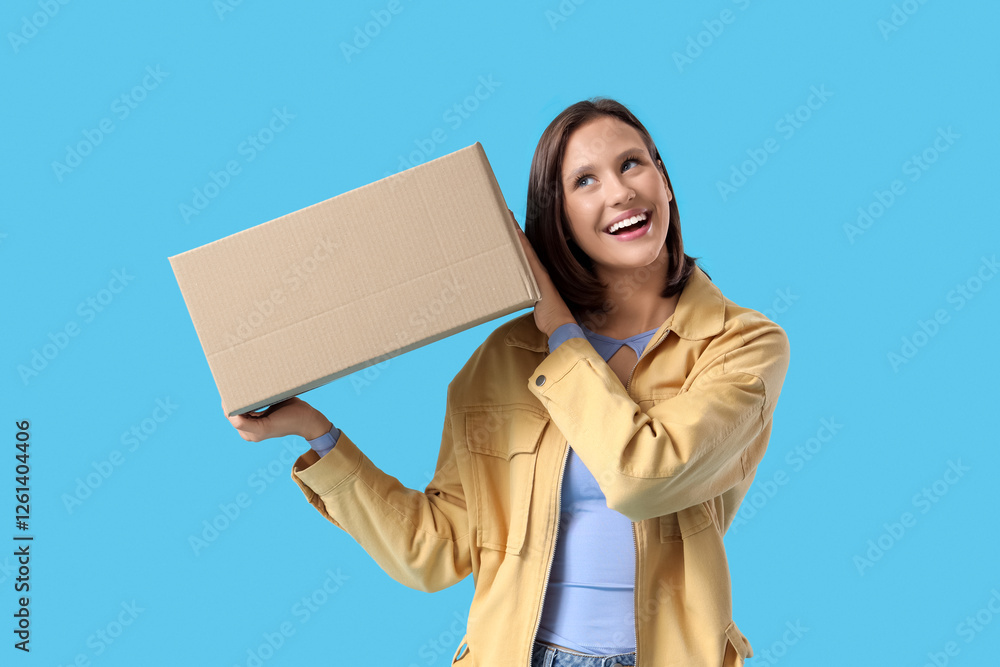 Beautiful young happy woman with parcel box on blue background Beautiful young happy woman with parcel box on blue background