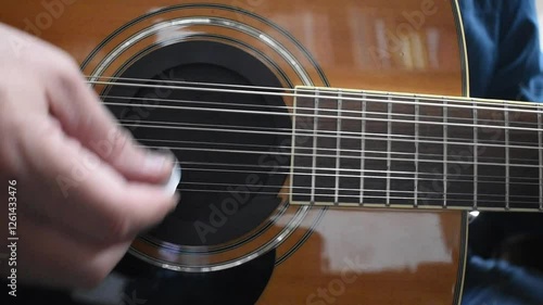 Strumming a Guitar in Slow Motion