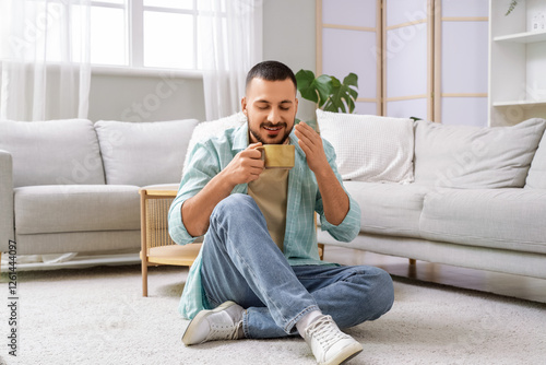 Young man with ceramic cup ...