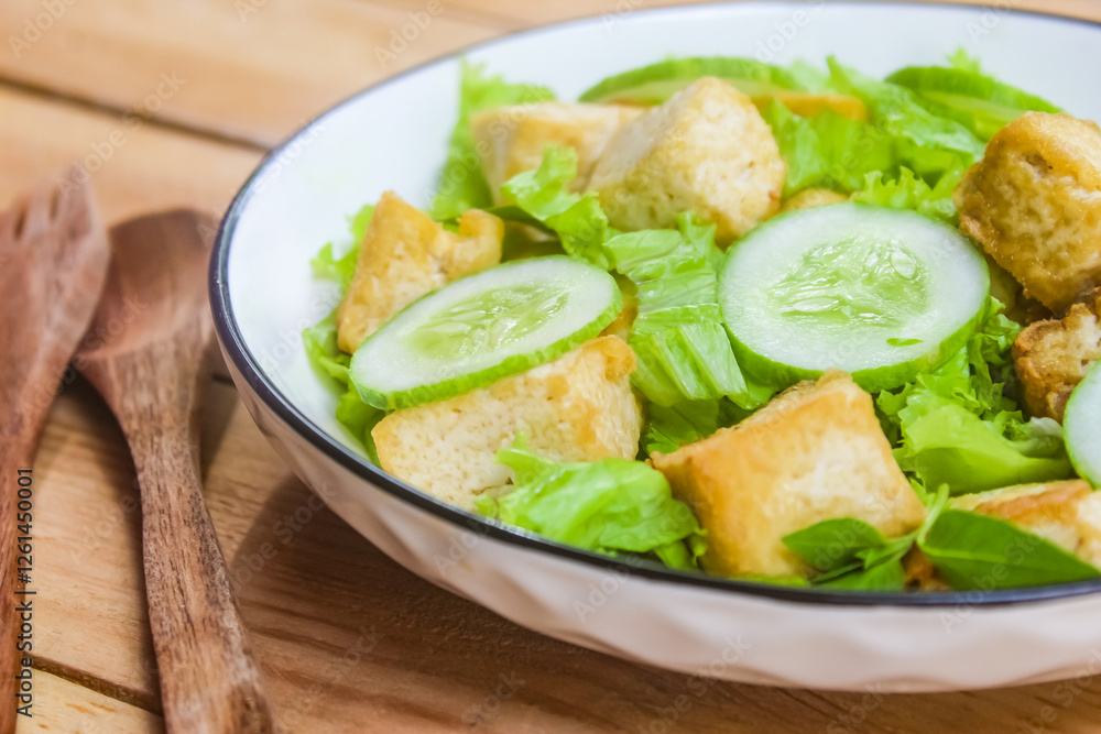 close-up of a plate of tofu salad on a wooden plate close-up of a plate of tofu salad on a wooden plate