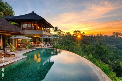 Luxury villa with infinity pool overlooking lush landscape at sunset in Bali