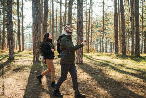 Wallpaper Mural Young caucasian couple boyfriend and girlfriend hiking or trekking through the forest Torontodigital.ca