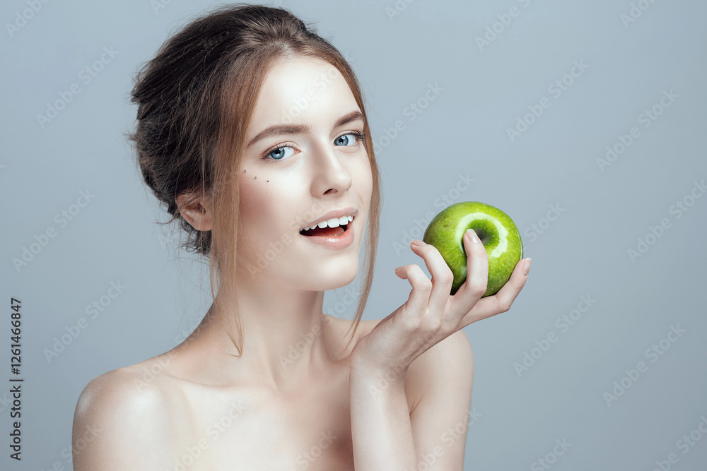 Photo of a close-up of a beautiful girl with a green apple in her hand. She has clean and even skin. Photo of a close-up of a beautiful girl with a green apple in her hand. She has clean and even skin.