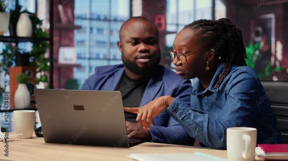 custom made wallpaper toronto digitalYoung couple doing teamwork and multitasking on laptop at desk, fully connected to the internet while managing freelance work and remote responsibilities. Browsing web at home. Camera B.