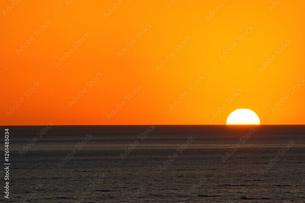Beautiful sunset over ocean with vibrant orange and golden colors Beautiful sunset over ocean with vibrant orange and golden colors