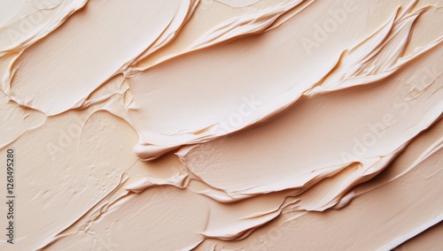 Light Beige Makeup Cream Texture Swirls on a Surface photo