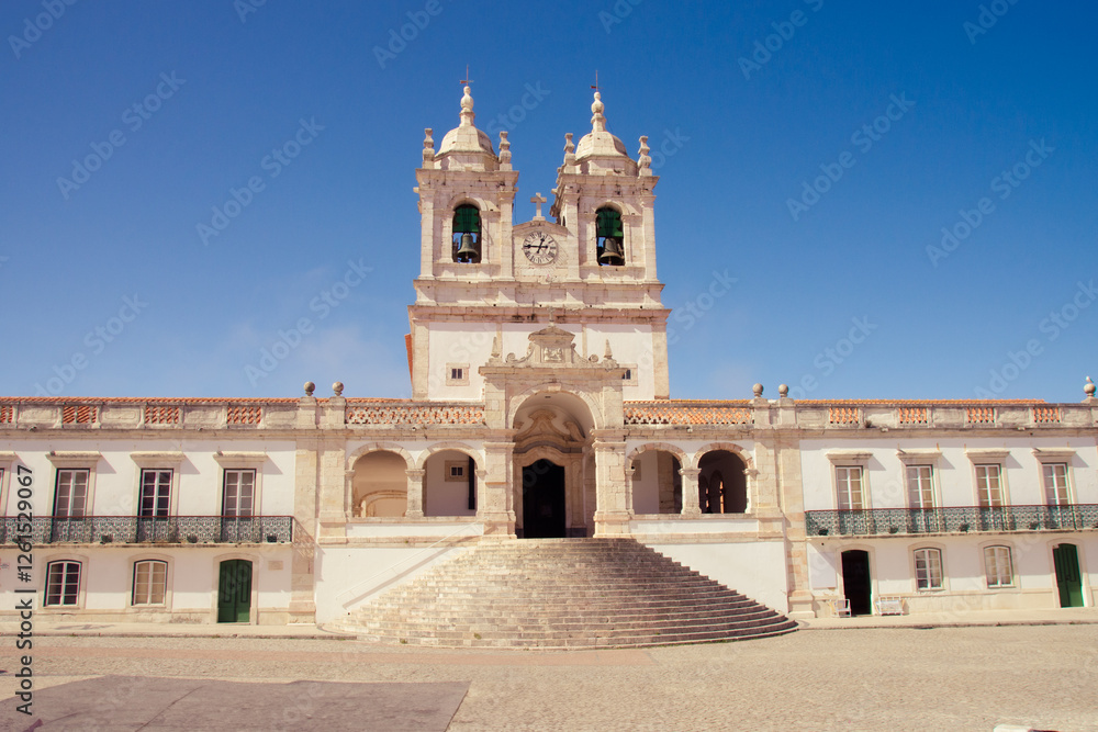 Bright and clear view of a historic church in Nazaré under a sunny sky. Bright and clear view of a historic church in Nazaré under a sunny sky.