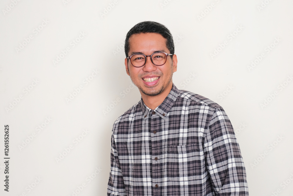 Adult Asian man wearing glasses smiling happy at the camera Adult Asian man wearing glasses smiling happy at the camera