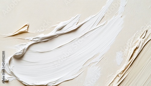 Creamy white paint strokes on beige canvas background photo