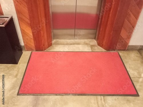 Red Entrance Mat In Front Of Elevator Entrance Area