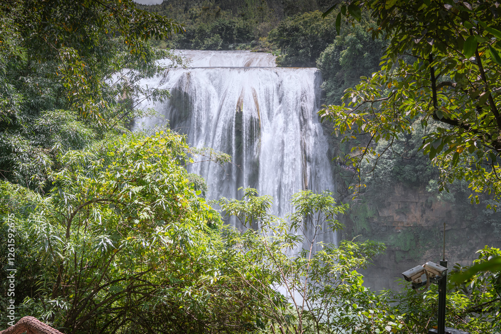 Huangguoshu Waterfall behind the trees in Guizhou Province, China Huangguoshu Waterfall behind the trees in Guizhou Province, China