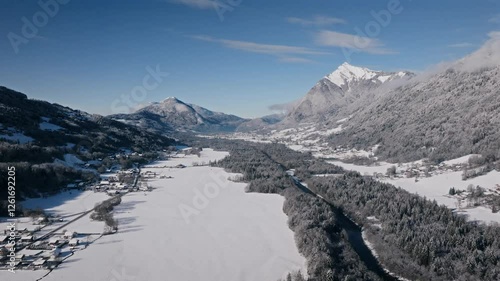 A stunning aerial view of the Giffre Valley covered in snow, with mountains in the distance photo