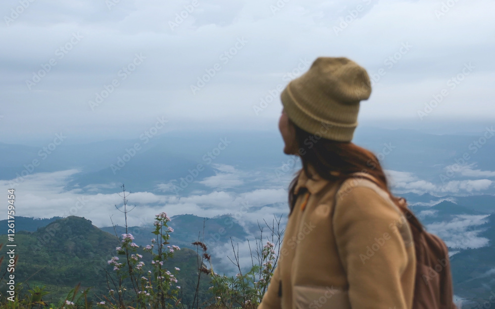 Blurred of a woman looking at a beautiful mountain views and the sea of fog Blurred of a woman looking at a beautiful mountain views and the sea of fog