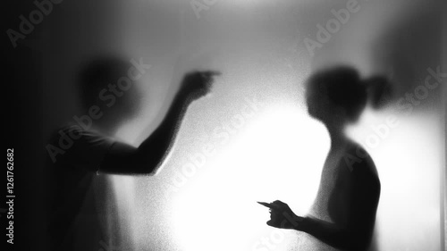 Couple arguing behind the frosted glass