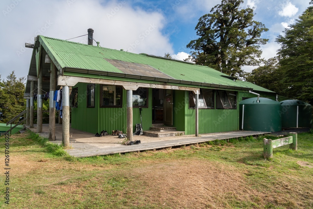 Hikers hut. Hikers' gear and water tanks are visible. Panekire Hut, Lake Waikaremoana Track, Hawkes Bay, New Zealand Hikers hut. Hikers' gear and water tanks are visible. Panekire Hut, Lake Waikaremoana Track, Hawkes Bay, New Zealand