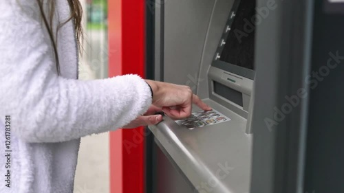 man hand entering PIN or pass code on ATM, bank machine secure keypad banking finance security