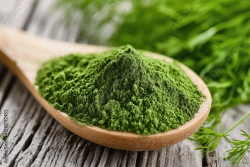 Green Powder in Wooden Spoon with Fresh Herbs photo