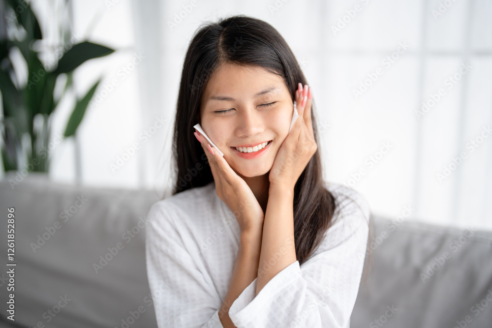 Daily beauty routine Asian woman.with clean skin uses micellar water to remove makeup Daily beauty routine Asian woman.with clean skin uses micellar water to remove makeup