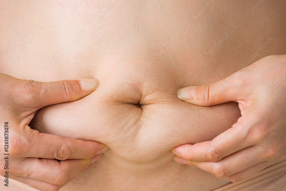 woman squeezes her belly fat woman squeezes her belly fat