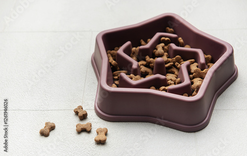 Slow feeder dog bowl filled with dry pet food preventing fast eating photo