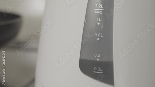 Water boiling in an electric kettle. Sound on.  電気ケトルでお湯を沸かす。音あり