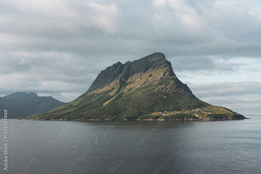 a mountain in a bay against a cloudy sky a mountain in a bay against a cloudy sky