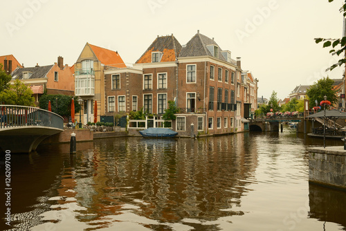 Picturesque canal reflecting traditional dutch houses photo