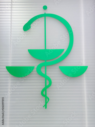The staff of Aesculapius wrapped in a snake is a sign of vitality and health. This sign can be seen on all medical facilities.Emblem of doctors and pharmacists.