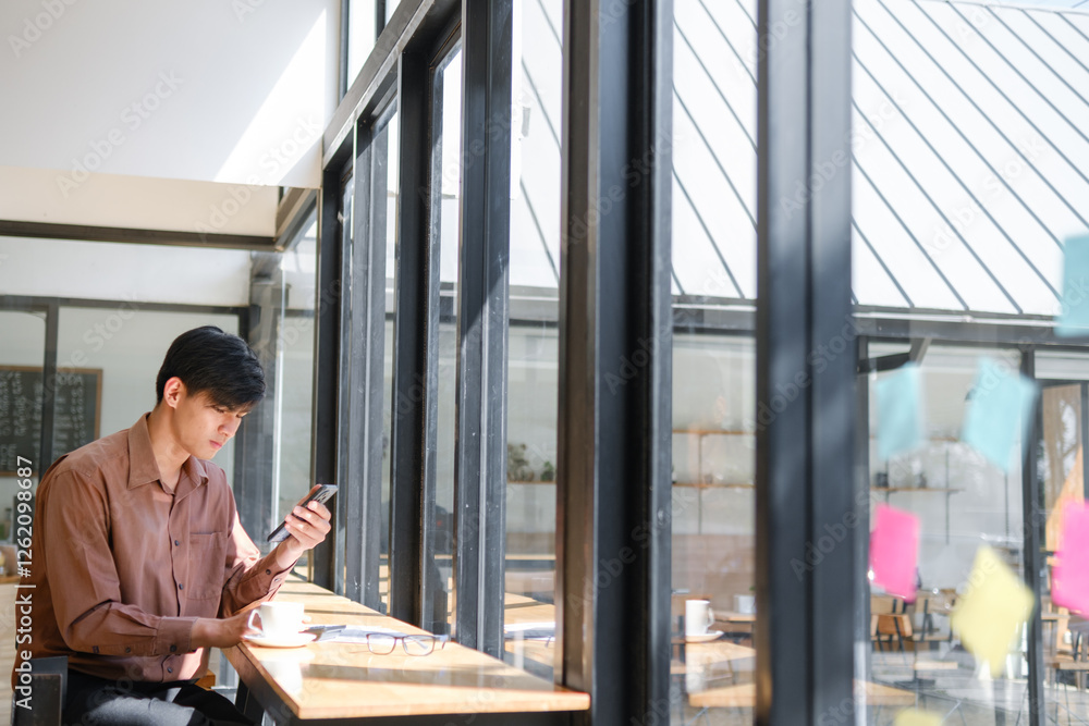 Businessman working remotely while checking phone messages