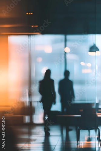 Silhouetted figures walking office window