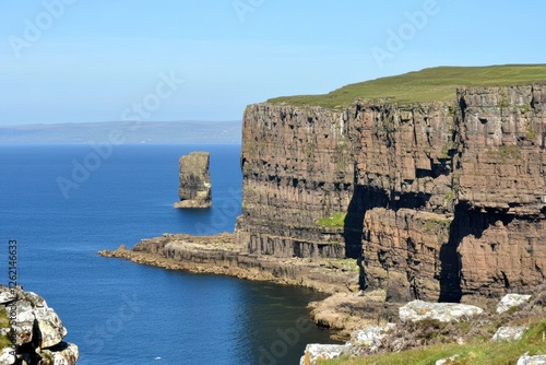 Majestic Sea Cliffs and Solitary Rock under Clear Blue Sky