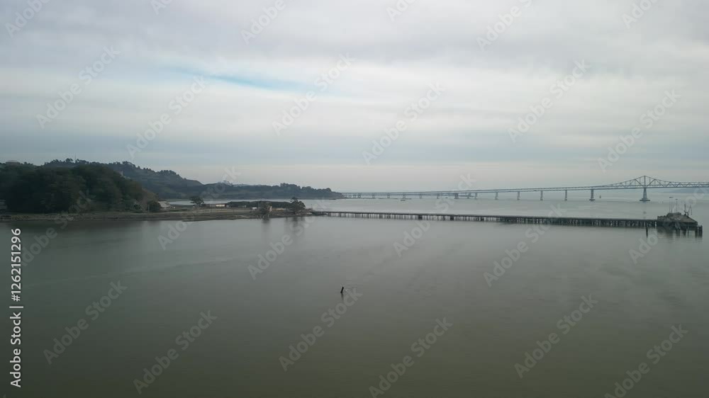 Coastal aerial drone shot of Point Molate Beach, showcasing the tranquil bay and nearby Richmond–San Rafael Bridge. Coastal aerial drone shot of Point Molate Beach, showcasing the tranquil bay and nearby Richmond–San Rafael Bridge.