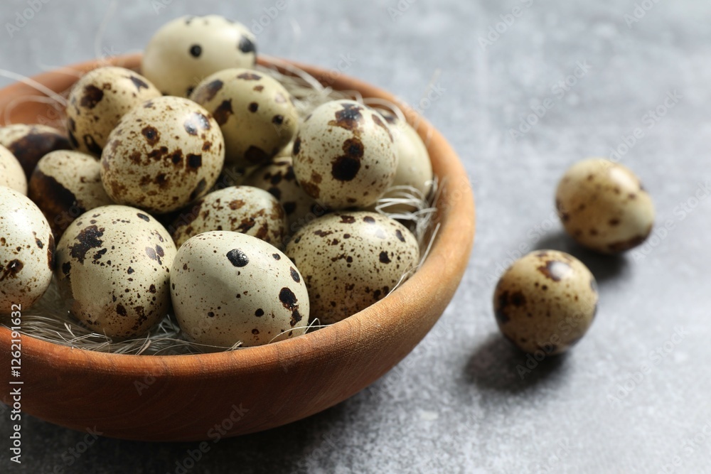 Quail eggs in a plate on gray background Quail eggs in a plate on gray background
