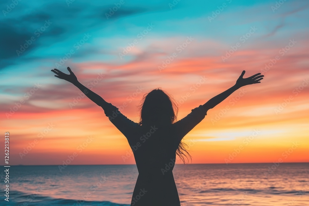 Fototapeta premium Silhouette of woman enjoying vibrant sunset by the ocean