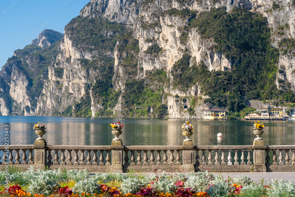 Riva del Garda, Italy: Scenic lakefront with flowers, mountain
