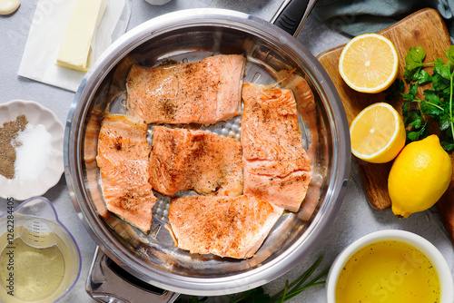 Trout picatta with capers and lemon in a frying pan..style hugge. photo