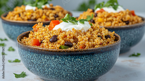 A clean arrangement of cooked quinoa, black beans, and Greek yogurt in individual bowls. photo