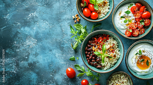 A clean arrangement of cooked quinoa, black beans, and Greek yogurt in individual bowls. photo