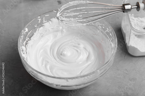 Powdered sugar with egg white in a bowl to make icing for gingerbread