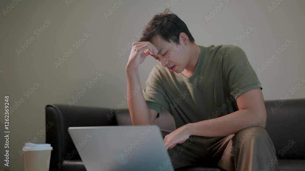 Overwhelmed by Work a man, exhausted and frustrated, works on his laptop late at night, overwhelmed by the pressures of modern life. Overwhelmed by Work a man, exhausted and frustrated, works on his laptop late at night, overwhelmed by the pressures of modern life.