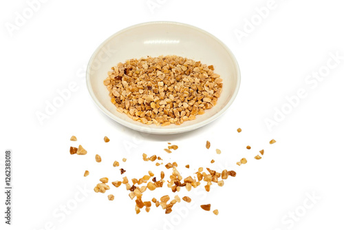 Crumbled Peanuts in a white bowl and scattered on isolated white background. Crushed Roasted Nuts, Heap of Chopped Nut Crumbs. Ground, milled, crushed or granulated peanut pile isolated.