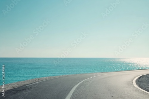 Fototapeta Naklejka Na Ścianę i Meble -  Winding road curves to turquoise sea; vast horizon; sunny day; travel inspiration