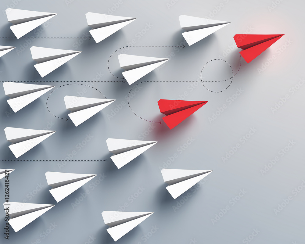 A concept image showcasing multiple white paper airplanes with one red airplane leading the way, symbolizing leadership, innovation, and uniqueness in business or creative thinking.