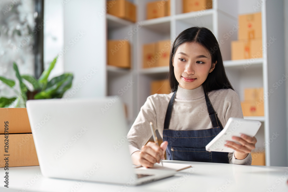 Thoughtful Asian woman reviewing e-commerce data on a tablet in a modern workspace. Thoughtful Asian woman reviewing e-commerce data on a tablet in a modern workspace.