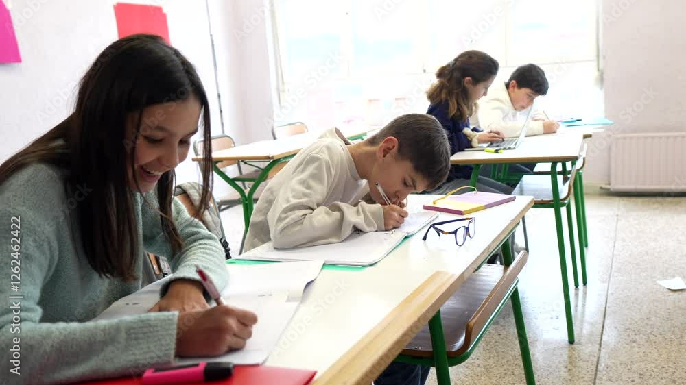 Diverse classroom scene featuring elementary students diligently writing, focused on academic assignments while seated at desks during learning session