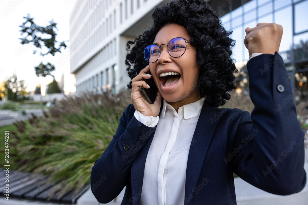 Curly-haired brunette business woman looking excited after having a good news Curly-haired brunette business woman looking excited after having a good news