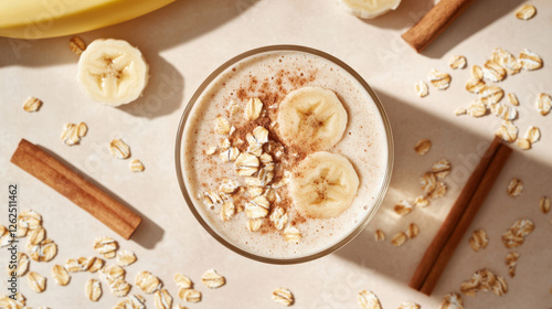 Wallpaper Mural Creamy banana oat protein shake topped with banana slices and oats, surrounded by cinnamon sticks and scattered oats, creating wholesome and nutritious vibe Torontodigital.ca