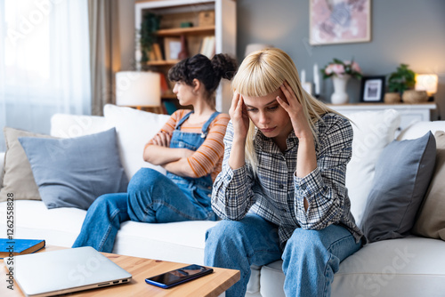 Young gay woman communicating with her girlfriend about problems in their relationship. Lesbian couple relationship difficulties communication problems. Roommates after argue not talking to each other