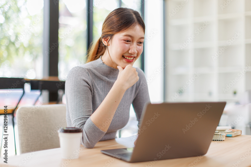 Beautiful young Asian woman working with laptop computer in working space. Work indoor. Remote studying, Virtual training, E-learning, Watching online education, Webinar online Beautiful young Asian woman working with laptop computer in working space. Work indoor. Remote studying, Virtual training, E-learning, Watching online education, Webinar online