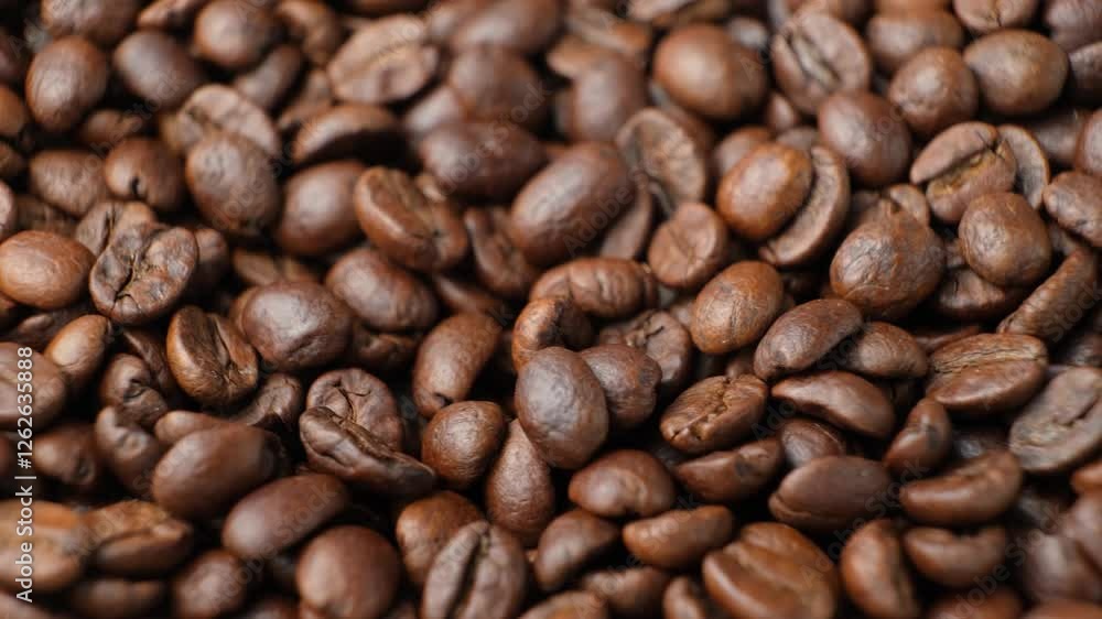 Rotating a pile of caffeine-free decaf coffee beans close-up Rotating a pile of caffeine-free decaf coffee beans close-up